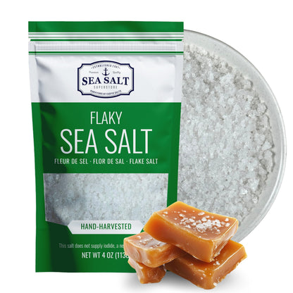 Mini Flake Sea Salt - 4 oz Pouch with flaky sea salt and caramel candy on a plate.