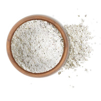 French Garden Blend Sea Salt 5 Lbs in a wooden bowl with a sprinkle beside it, ideal for seasoning meats and vegetables.