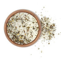 French Harvest Sea Salt 5 Lbs in a ceramic bowl with herbs and garlic, enhancing meals with natural flavors.