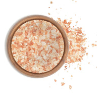 Himalayan Pink Salt - Extra Coarse in a wooden bowl, showcasing its natural pink hue and coarse grain.